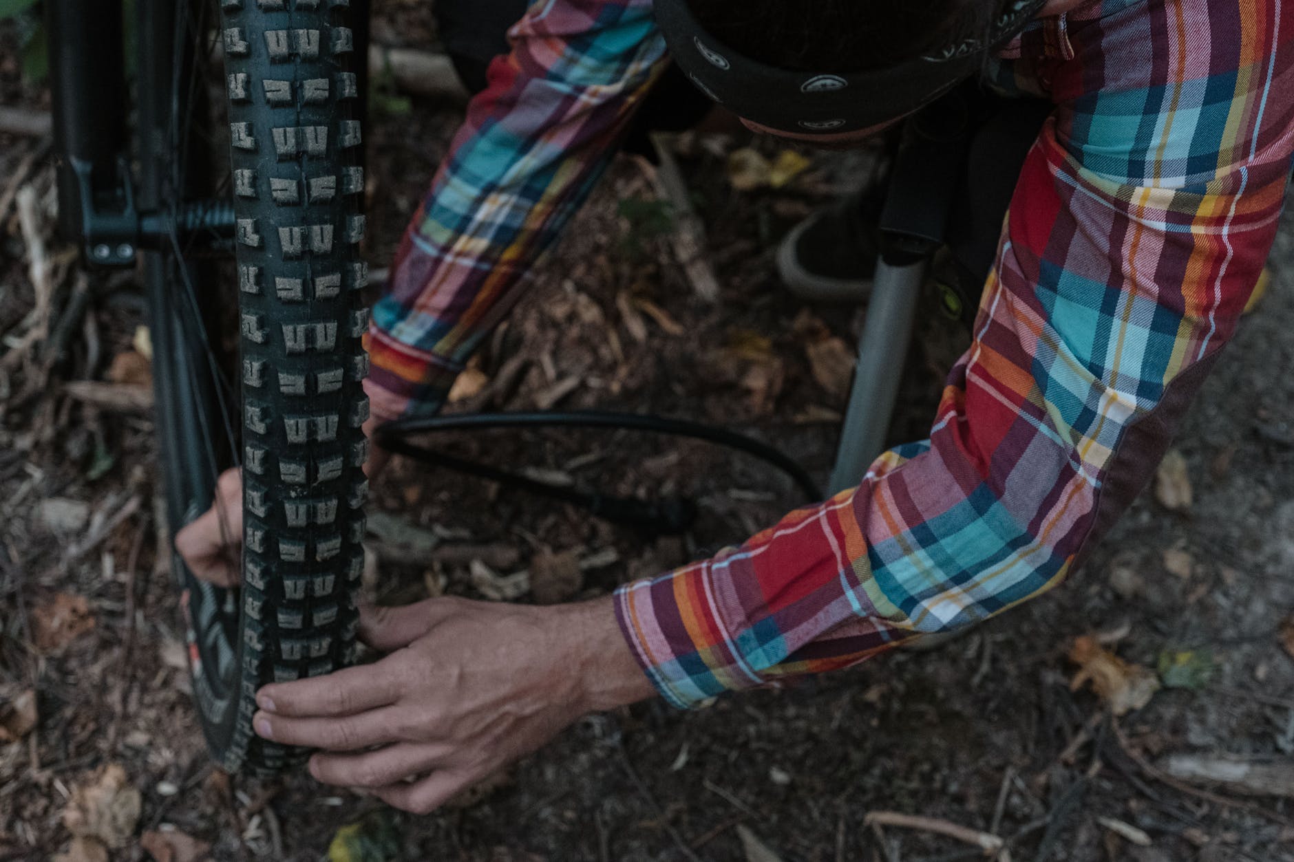 photo of a man s hands fixing a bike tire